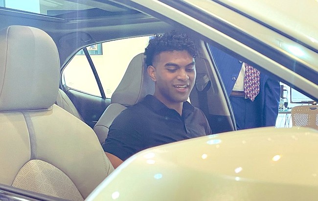 Kansas guard Remy Martin sits in the driver's seat of his new Toyota Camry after signing an NIL deal with Crown Toyota on Thursday, Oct. 28, 2021 in Lawrence. 