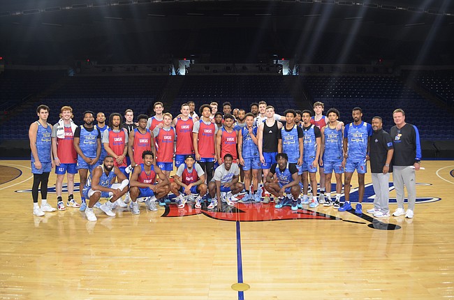 The Kansas and Tulsa men's basketball teams pose for a photo together at a closed-door scrimmage in Tulsa on Saturday, Oct. 30, 2021.
