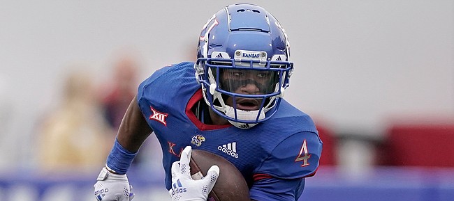 Kansas running back Devin Neal runs the ball during the first half of an NCAA college football game against Oklahoma Saturday, Oct. 23, 2021, in Lawrence, Kan. (AP Photo/Charlie Riedel)
