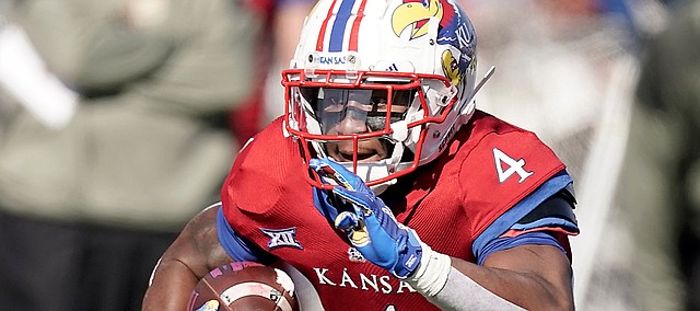 Kansas running back Devin Neal (4) runs during the first half of an NCAA football basketball game against Kansas State Saturday, Nov. 6, 2021, in Lawrence, Kan. (AP Photo/Charlie Riedel)