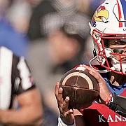 Kansas quarterback Miles Kendrick (3) looks to pass during the first half of an NCAA football basketball game against Kansas State Saturday, Nov. 6, 2021, in Lawrence, Kan. (AP Photo/Charlie Riedel)