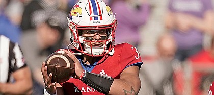 Kansas quarterback Miles Kendrick (3) looks to pass during the first half of an NCAA football basketball game against Kansas State Saturday, Nov. 6, 2021, in Lawrence, Kan. (AP Photo/Charlie Riedel)