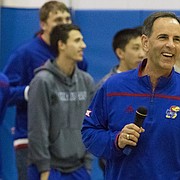 Kansas University volleyball coach Ray Bechard flashes a big grin toward the crowd gathered in the Horejsi Center to welcome histeam back to Lawrence on Sunday.