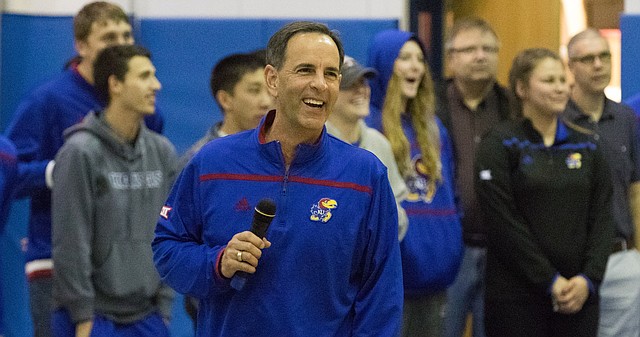 Kansas University volleyball coach Ray Bechard flashes a big grin toward the crowd gathered in the Horejsi Center to welcome histeam back to Lawrence on Sunday.