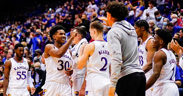 Kansas guard Ochai Agbaji (30) gets a round of fist bumps after checking out of the game with 25 points on Thursday, Nov. 18, 2021 at Allen Fieldhouse.