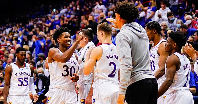 Kansas guard Ochai Agbaji (30) gets a round of fist bumps after checking out of the game with 25 points on Thursday, Nov. 18, 2021 at Allen Fieldhouse.
