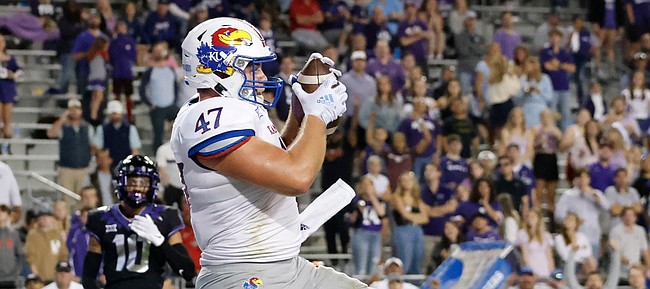 Kansas fullback Jared Casey catches a touchdown pass in front of TCU linebacker Dee Winters during the second half of a game on Nov. 20, 2021, in Fort Worth, Texas.