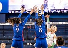 Kansas volleyball's Caroline Crawford and Anezka Szabo extend their arms above the net to go after a block, during the Jayhawks' NCAA Tournament matchup with Oregon, on Dec. 2, 2021, in Omaha, Neb.