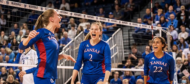 Kansas volleyball teammates Jenny Mosser, Rachel Langs and Camryn Turner celebrate after a KU point during a second-round NCAA Tournament match versus Creighton at D.J. Sokol Arena in Omaha, Neb., on Dec. 3, 2021.