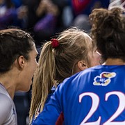 Kansas volleyball players, including outside hitter Caroline Bien (smiling), celebrate after a point during the Jayhawks' NCAA Tournament win over Oregon,  on Dec. 2, 2021, in Omaha, Neb.