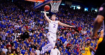 Kansas guard Christian Braun (2) soars in for a dunk against Missouri during the first half on Saturday, Dec. 11, 2021, at Allen Fieldhouse.