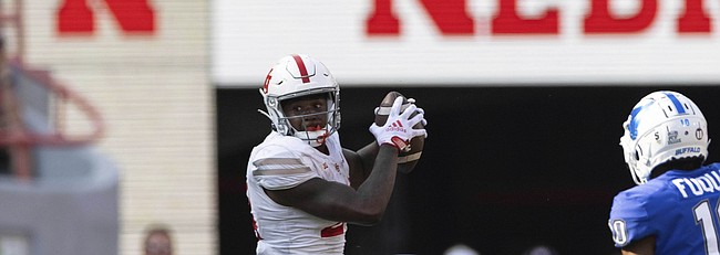 In this file photo, former Nebraska running back Sevion Morrison, left, receives a pass ahead of Buffalo safety Marcus Fuqua during the second half of an NCAA college football game Saturday, Sept. 11, 2021, at Memorial Stadium in Lincoln, Neb. Morrison announced on Dec. 12, 2021, his plans to transfer to Kansas. (AP Photo/Rebecca S. Gratz)