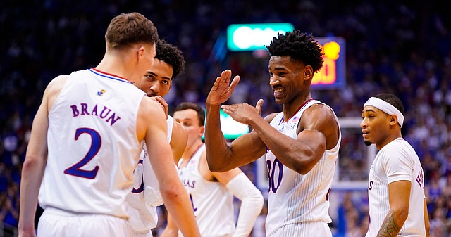 Kansas guard Ochai Agbaji (30) has a laugh with his teammates during a break in action in the second half on Saturday, Dec. 11, 2021, at Allen Fieldhouse.
