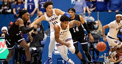Kansas guard Ochai Agbaji (30) chases down a loose ball during the first half on Saturday, Dec. 18, 2021 at Allen Fieldhouse.