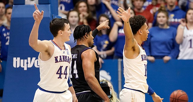 Kansas forward Mitch Lightfoot (44) and Kansas forward Jalen Wilson (10) look for a ball going the Jayhawks way while Stephen F. Austin forward Gavin Kensmil (14) signals the opposite during the first half on Saturday, Dec. 18, 2021 at Allen Fieldhouse.