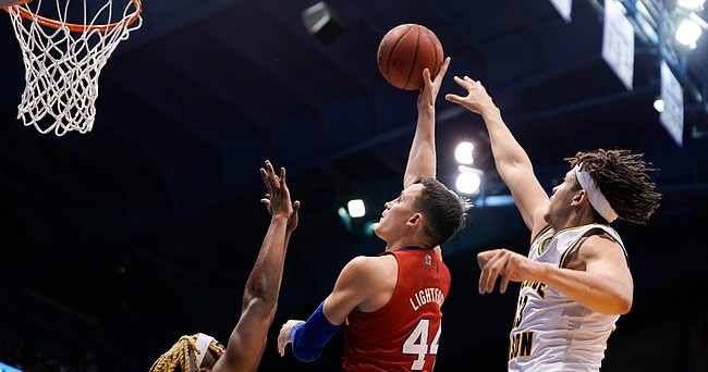 Kansas forward Mitch Lightfoot (44) turns for a shot over George Mason guard Ronald Polite III (1) during the second half on Saturday, Jan. 1, 2022 at Allen Fieldhouse. At right is George Mason forward Josh Oduro (13).