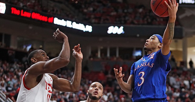 Kansas' Dajuan Harris Jr. (3) lays up the ball over Texas Tech's Bryson Williams (11) and Kevin Obanor (0) during the first half of an NCAA college basketball game on Saturday, Jan. 8, 2022, in Lubbock, Texas. (AP Photo/Brad Tollefson)



