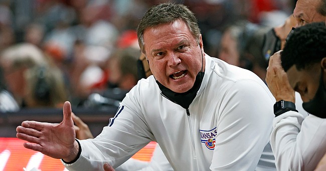 Kansas coach Bill Self talks to his team on the bench during the first half of an NCAA college basketball game against Texas Tech, Saturday, Jan. 8, 2022, in Lubbock, Texas. (AP Photo/Brad Tollefson)