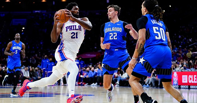 Philadelphia 76ers' Joel Embiid (21) tries to get past Orlando Magic's Franz Wagner (22) and Cole Anthony (50) during the first half of an NBA basketball game, Wednesday, Jan. 19, 2022, in Philadelphia. (AP Photo/Matt Slocum)


