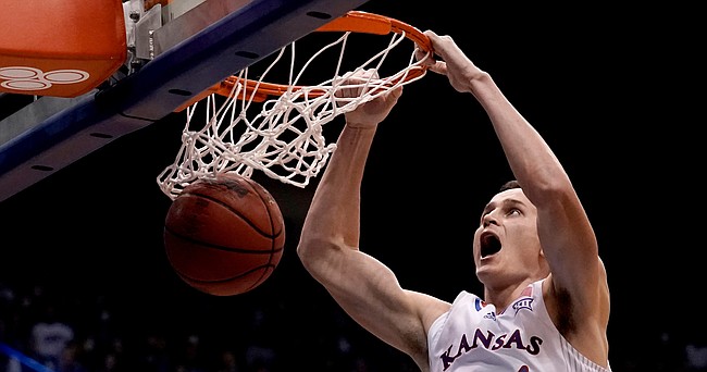 Kansas's Mitch Lightfoot dunks the ball during the first half of an NCAA college basketball game against Stony Brook Thursday, Nov. 18, 2021, in Lawrence, Kan. (AP Photo/Charlie Riedel)