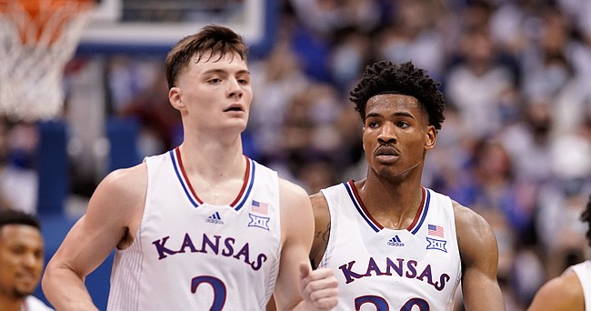 Kansas players dismayed with the lopsided game, make their way back to the huddle during a timeout in the second half on Saturday, Jan. 29, 2022 at Allen Fieldhouse.