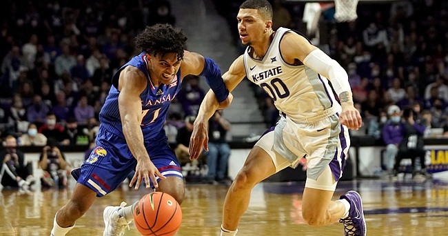 Kansas guard Remy Martin (11) drives against Kansas State guard Mike McGuirl (00) during the second half on Saturday, Jan. 22, 2022 at Bramlage Coliseum.
