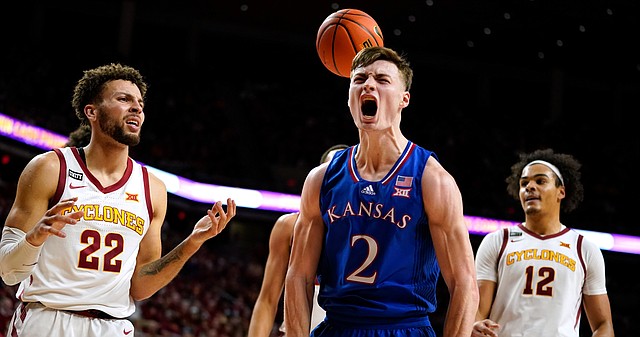 Kansas guard Christian Braun (2) celebrates ahead of Iowa State guard Gabe Kalscheur (22) and forward Robert Jones (12) after making a basket during the second half of an NCAA college basketball game, Tuesday, Feb. 1, 2022, in Ames, Iowa. (AP PhotoCharlie Neibergall)