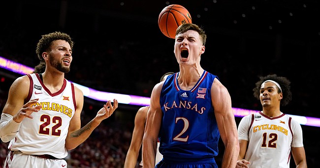 Kansas guard Christian Braun (2) celebrates ahead of Iowa State guard Gabe Kalscheur (22) and forward Robert Jones (12) after making a basket during the second half of an NCAA college basketball game, Tuesday, Feb. 1, 2022, in Ames, Iowa. (AP PhotoCharlie Neibergall)