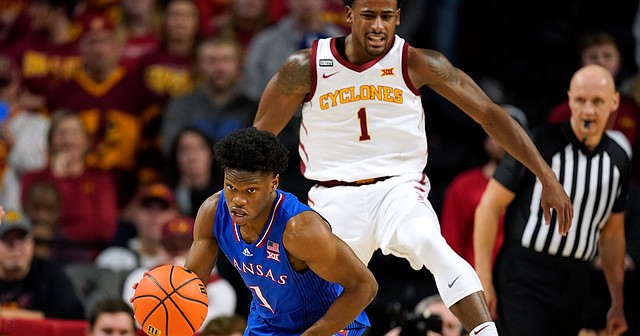 Kansas guard Joseph Yesufu drives up court ahead of Iowa State guard Izaiah Brockington, right, during the second half of an NCAA college basketball game, Tuesday, Feb. 1, 2022, in Ames, Iowa. (AP Photo/Charlie Neibergall)