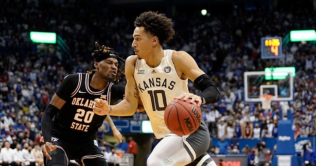 Kansas forward Jalen Wilson (10) drives to the bucket against Oklahoma State guard Keylan Boone (20) during the first half on Monday, Feb. 14, 2022 at Allen Fieldhouse.