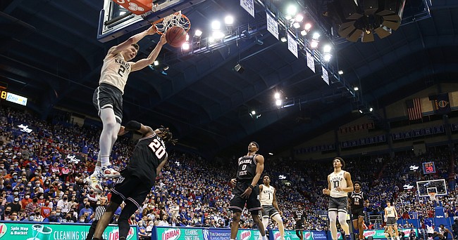 Kansas guard Christian Braun (2) gets up for a jam over Oklahoma State guard Keylan Boone (20) during the second half on Monday, Feb. 14, 2022 at Allen Fieldhouse.