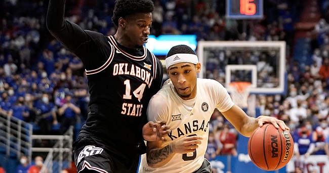 Kansas guard Dajuan Harris Jr. (3) pushes inside against Oklahoma State guard Bryce Williams (14) during the second half on Monday, Feb. 14, 2022 at Allen Fieldhouse.