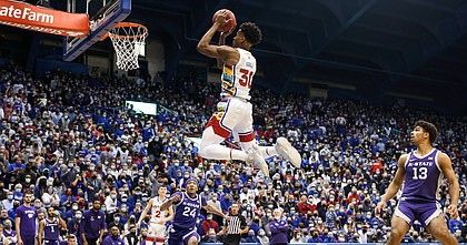 Kansas guard Ochai Agbaji (30) gets airborne for a bucket against Kansas State during the first half on Tuesday, Feb. 22, 2022 at Allen Fieldhouse.