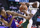 Kansas guard Aniya Thomas, left, fouls Baylor guard Ja'Mee Asberry, right, in the first half of an NCAA college basketball game, Saturday, Feb. 26, 2022, in Waco, Texas.