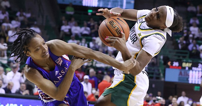 Kansas guard Aniya Thomas, left, fouls Baylor guard Ja'Mee Asberry, right, in the first half of an NCAA college basketball game, Saturday, Feb. 26, 2022, in Waco, Texas.