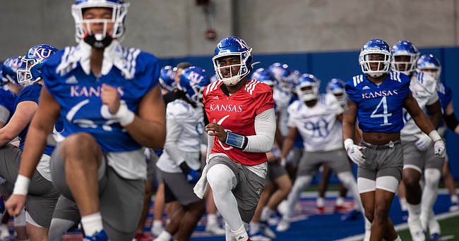 Kansas junior quarterback Jalon Daniels gets loose during spring practice at the indoor practice facility on Tuesday, March 1, 2022.