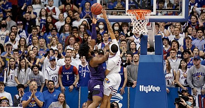 Kansas guard Dajuan Harris Jr. (3) gets up to get a hand on a final shot from TCU guard Mike Miles (1) with seconds remaining in the second half on Tuesday, March 3, 2022 at Allen Fieldhouse.