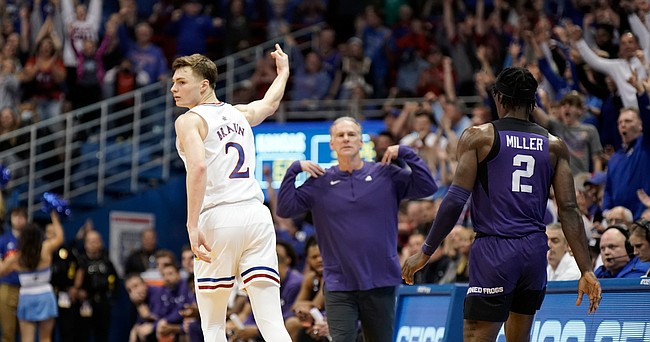 Kansas guard Christian Braun (2) signals "three" as TCU head coach Jamie Dixon signals for a time out after Braun hit a three-pointer late in the second half on Tuesday, March 3, 2022 at Allen Fieldhouse.