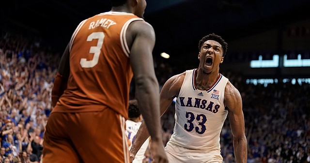 Kansas forward David McCormack (33) roars after a dunk before Texas guard Courtney Ramey (3) during overtime on Saturday, March 5, 2022 at Allen Fieldhouse. The Jayhawks defeated the Longhorns, 70-63 to win a share of the Big 12 conference title.