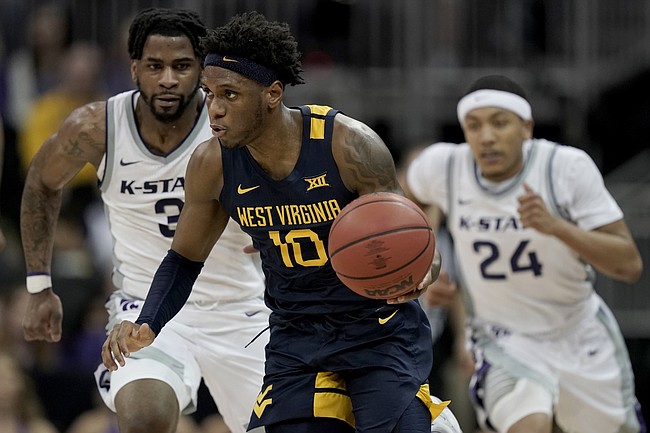 West Virginia guard Malik Curry (10) is chased by Kansas State guards Selton Miguel (3) and Nijel Pack (24) during the second half of an NCAA college basketball game in the first round of the Big 12 Conference tournament in Kansas City, Mo., Wednesday, March 9, 2022. West Virginia won 73-67. (AP Photo/Charlie Riedel)


