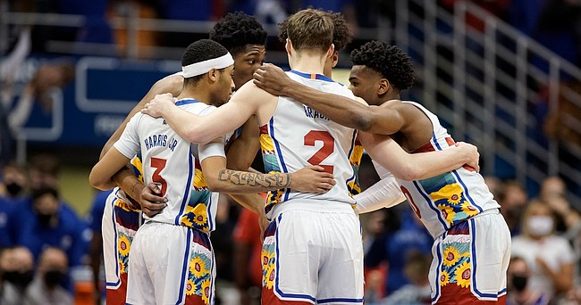 The Kansas starters huddle up before tipoff against Kansas State during the first half on Tuesday, Feb. 22, 2022 at Allen Fieldhouse.