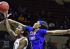 Kansas junior Taiyanna Jackson tries to block a shot by Oklahoma's Kennady Tucker during the Big 12 quarterfinal game at Municipal Auditorium in Kansas City, Missouri, on March 11, 2022.
