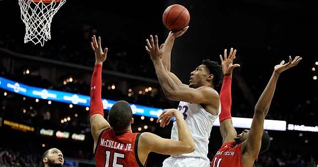Kansas forward David McCormack (33) puts up a shot against the Texas Tech defense during the second half of the Big 12 Tournament championship game on Saturday, March 12, 2022 at T-Mobile Center in Kansas City.
