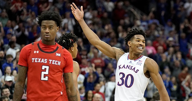 Kansas guard Ochai Agbaji (30) waves to the Kansas fans as time runs out in the Jayhawks' 74-65 Big 12 Tournament championship win over Texas Tech on Saturday, March 12, 2022 at T-Mobile Center in Kansas City.