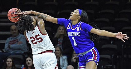 Kansas women's basketball player Taiyanna Jackson, right, blocks a shot by Oklahoma's Mady Williams during the Big 12 quarterfinal game against Oklahoma at Municipal Auditorium in Kansas City, Missouri, on March 11, 2022.