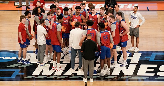 The Kansas Jayhawks come together at half court to start off their open practice on Wednesday, March 16, 2022 at Dickies Arena in Fort Worth, Texas.