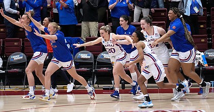 Kansas players celebrate after defeating Georgia Tech of a first-round game in the NCAA women's college basketball tournament Friday, March 18, 2022, in Stanford, Calif.