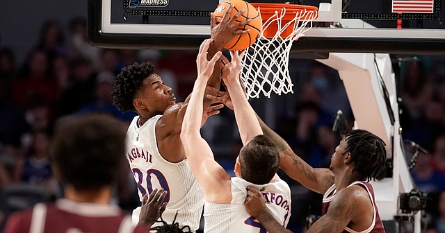 Kansas guard Ochai Agbaji (30) gets up over the pack for a rebound against Texas Southern during the first half on Thursday, March 17, 2022 at Dickies Arena in Fort Worth, Texas.