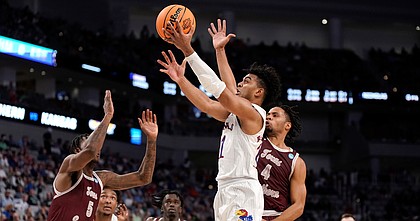 Kansas guard Remy Martin (11) gets past Texas Southern guard Bryson Etienne (4) for a bucket during the first half on Thursday, March 17, 2022 at Dickies Arena in Fort Worth, Texas.