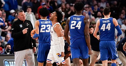 Kansas guard Remy Martin (11) roars in front of the Creighton bench during a run by the Jayhawks in the second half on Saturday, March 19, 2022 at Dickies Arena in Fort Worth, Texas. The Jayhawks advanced to the Sweet 16 with a 79-72 win over the Bluejays.